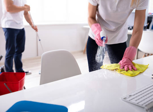 A group of people cleaning up in an office.